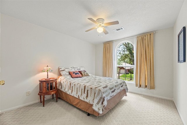 2218 Lashley Ct, Katy, TX 77450 - bedroom with light carpet, ceiling fan, and a textured ceiling