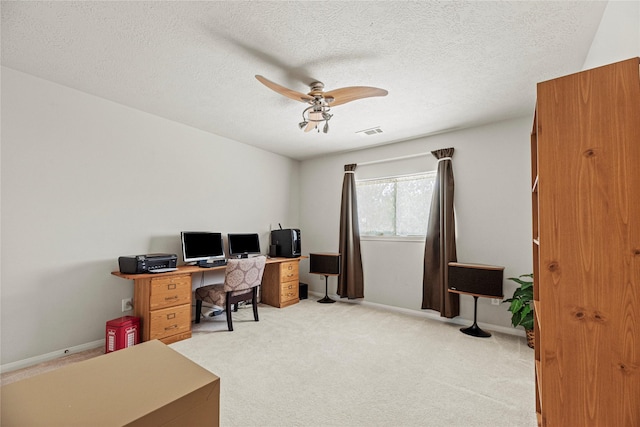 2218 Lashley Ct, Katy, TX 77450 - home office featuring a ceiling fan, light colored carpet, and a textured ceiling