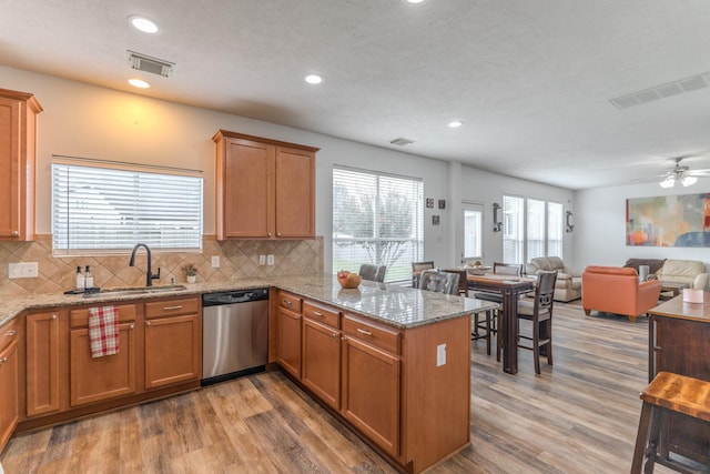 3618 Avalon Spring Ln, Spring, TX 77386 - kitchen featuring a peninsula, light wood-type flooring, dishwasher, decorative backsplash, and recessed lighting
