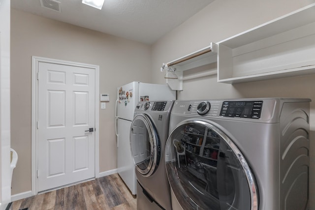 3618 Avalon Spring Ln, Spring, TX 77386 - washroom with washing machine and clothes dryer and wood finished floors