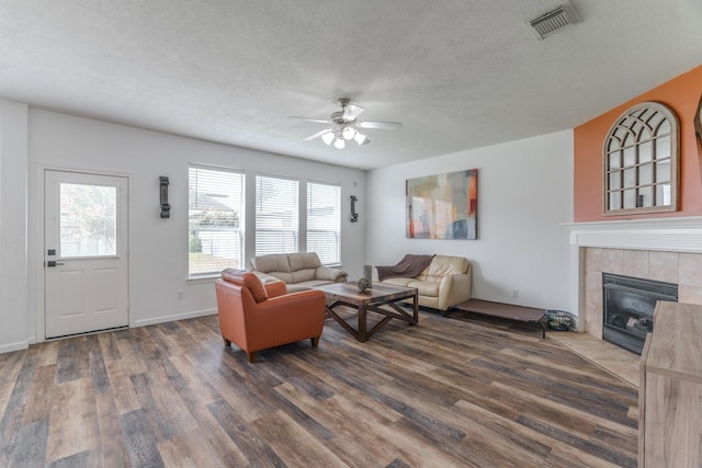 3618 Avalon Spring Ln, Spring, TX 77386 - living area with dark wood finished floors, a ceiling fan, a textured ceiling, plenty of natural light, and a fireplace