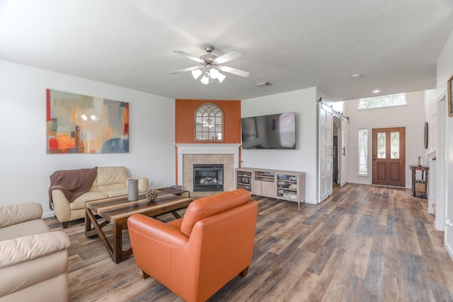 3618 Avalon Spring Ln, Spring, TX 77386 - living area with a barn door, wood finished floors, ceiling fan, and a fireplace