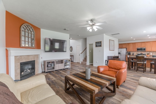 3618 Avalon Spring Ln, Spring, TX 77386 - living room with dark wood-style flooring, stairs, ceiling fan, recessed lighting, and a tile fireplace