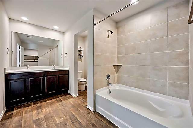 22835 Berthoud Trl, Spring, TX 77373 - full bathroom with double vanity, wood finished floors, shower / bathtub combination, and recessed lighting