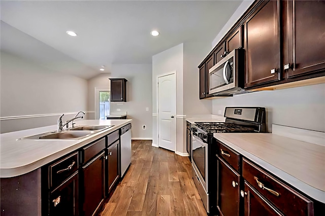 22835 Berthoud Trl, Spring, TX 77373 - kitchen featuring stainless steel appliances, wood finished floors, light countertops, recessed lighting, and vaulted ceiling