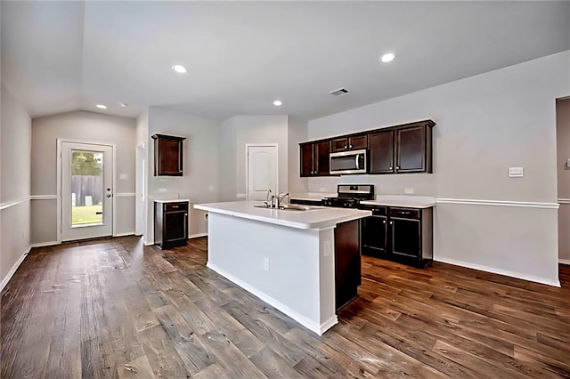 22835 Berthoud Trl, Spring, TX 77373 - kitchen with dark wood-style floors, light countertops, stainless steel microwave, recessed lighting, and lofted ceiling