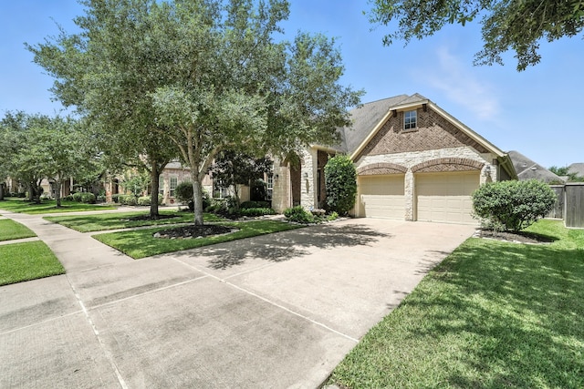 4118 Sage Brush Ct, Manvel, TX 77578 - view of front of property with brick siding, concrete driveway, a front yard, and a garage