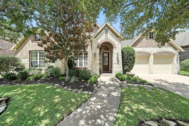4118 Sage Brush Ct, Manvel, TX 77578 - view of front of home with brick siding, concrete driveway, stone siding, and a garage
