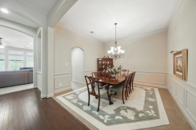 4118 Sage Brush Ct, Manvel, TX 77578 - dining area featuring arched walkways, a ceiling fan, a decorative wall, wainscoting, and wood-type flooring