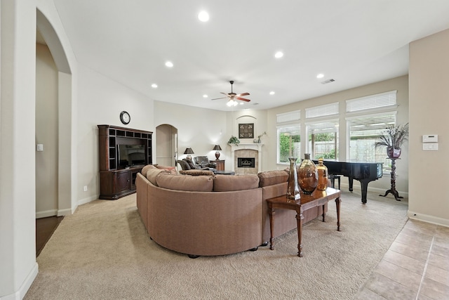 4118 Sage Brush Ct, Manvel, TX 77578 - living area featuring arched walkways, ceiling fan, a tiled fireplace, recessed lighting, and light carpet