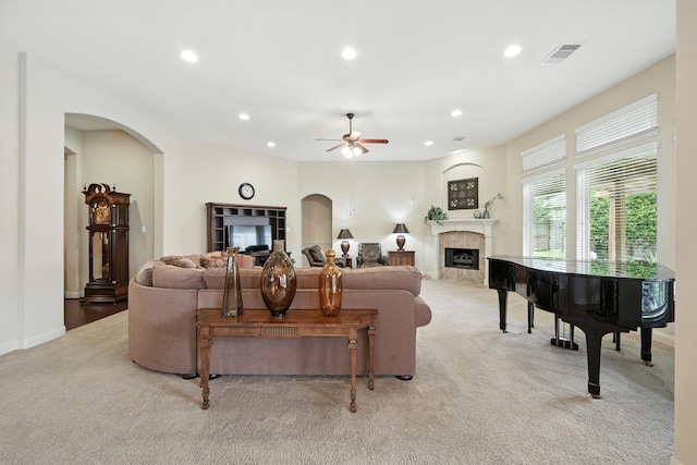 4118 Sage Brush Ct, Manvel, TX 77578 - living area with a fireplace, carpet flooring, a ceiling fan, recessed lighting, and arched walkways