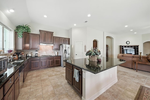 4118 Sage Brush Ct, Manvel, TX 77578 - kitchen featuring tasteful backsplash, appliances with stainless steel finishes, a kitchen island, dark stone counters, and dark brown cabinets