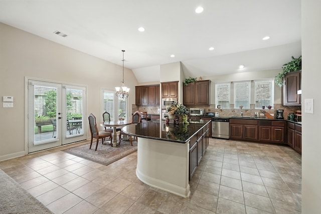 4118 Sage Brush Ct, Manvel, TX 77578 - kitchen with vaulted ceiling, backsplash, light tile patterned floors, a chandelier, and appliances with stainless steel finishes