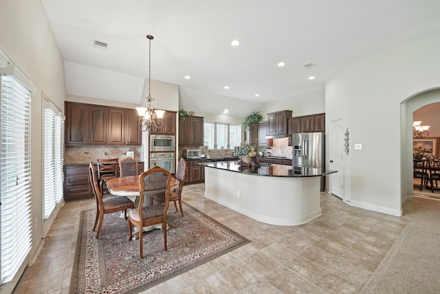 4118 Sage Brush Ct, Manvel, TX 77578 - dining room featuring a chandelier, arched walkways, and recessed lighting