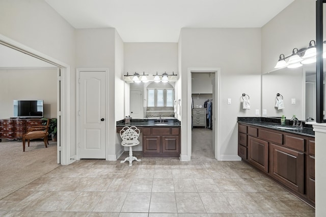 4118 Sage Brush Ct, Manvel, TX 77578 - bathroom featuring two vanities and a walk in closet