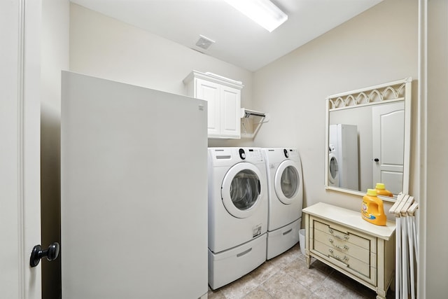 4118 Sage Brush Ct, Manvel, TX 77578 - laundry room featuring washing machine and clothes dryer, cabinet space, and light tile patterned floors