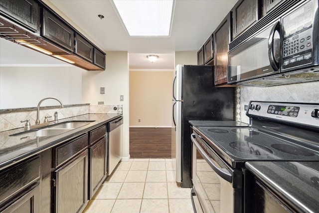 3525 Sage Rd Unit 805, Houston, TX 77056 - kitchen featuring appliances with stainless steel finishes, backsplash, light tile patterned floors, dark brown cabinets, and ornamental molding