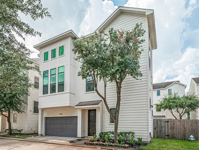9027 Laverne Cres, Houston, TX 77080 - view of front of home with stucco siding, a garage, and driveway