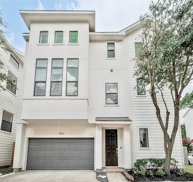 9027 Laverne Cres, Houston, TX 77080 - contemporary home featuring stucco siding, concrete driveway, and an attached garage