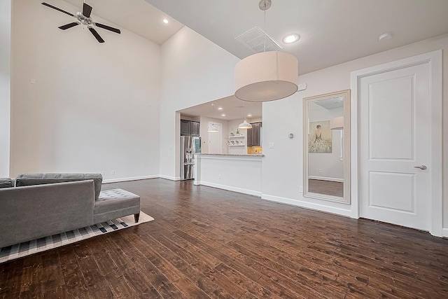9027 Laverne Cres, Houston, TX 77080 - living area featuring dark wood-style flooring, ceiling fan, and high vaulted ceiling