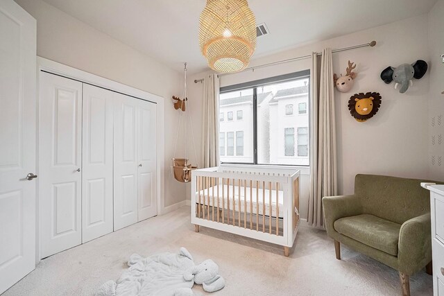 9027 Laverne Cres, Houston, TX 77080 - bedroom with a closet, light carpet, and a crib