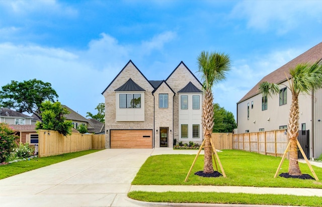 3909 Ella Blvd, Houston, TX 77018 - view of front of home with driveway, a garage, and a standing seam roof