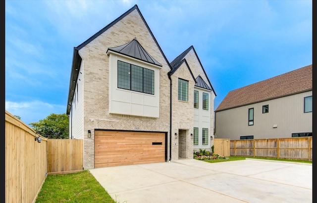 3909 Ella Blvd, Houston, TX 77018 - modern home with brick siding, a standing seam roof, driveway, and a metal roof