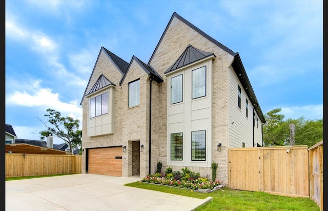 3909 Ella Blvd, Houston, TX 77018 - contemporary house featuring brick siding, an attached garage, concrete driveway, a standing seam roof, and a metal roof
