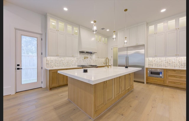 3909 Ella Blvd, Houston, TX 77018 - kitchen with stainless steel built in refrigerator, light wood finished floors, light countertops, backsplash, and recessed lighting