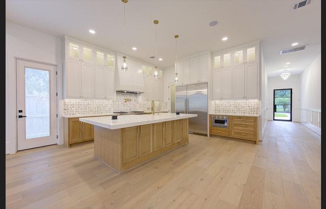 3909 Ella Blvd, Houston, TX 77018 - kitchen featuring light wood-style flooring, light countertops, built in refrigerator, decorative backsplash, and recessed lighting