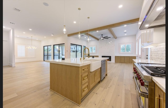 3909 Ella Blvd, Houston, TX 77018 - kitchen featuring open floor plan, a high end fireplace, range with two ovens, light wood finished floors, and beamed ceiling