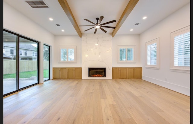 3909 Ella Blvd, Houston, TX 77018 - unfurnished living room featuring light wood-style flooring, beamed ceiling, ceiling fan, a fireplace, and recessed lighting