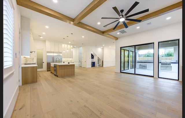3909 Ella Blvd, Houston, TX 77018 - unfurnished living room with beam ceiling, light wood-style flooring, a ceiling fan, recessed lighting, and stairs