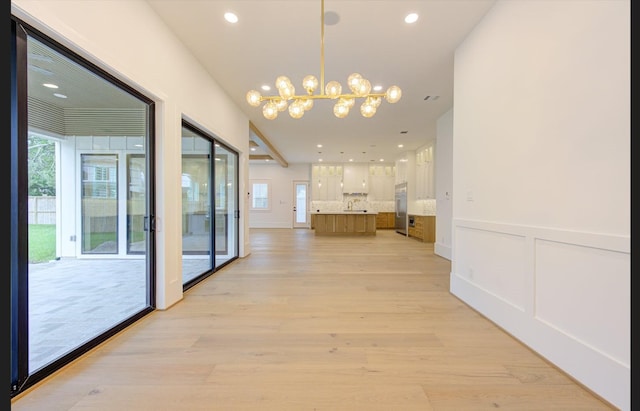 3909 Ella Blvd, Houston, TX 77018 - hall with a chandelier, healthy amount of natural light, light wood-style flooring, and recessed lighting