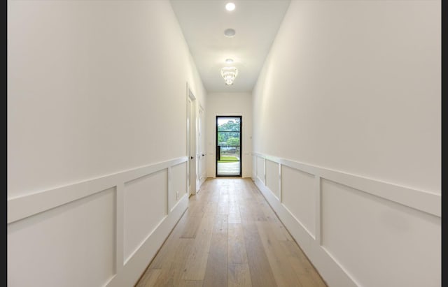 3909 Ella Blvd, Houston, TX 77018 - hall with light wood finished floors, a decorative wall, a wainscoted wall, and recessed lighting