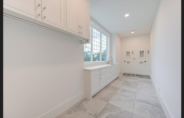 3909 Ella Blvd, Houston, TX 77018 - laundry room featuring washer hookup, cabinet space, light marble finish flooring, and recessed lighting