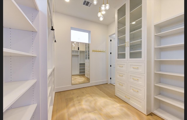3909 Ella Blvd, Houston, TX 77018 - spacious closet featuring light wood finished floors and a chandelier