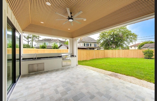 3909 Ella Blvd, Houston, TX 77018 - fenced backyard featuring exterior kitchen, a patio area, and ceiling fan
