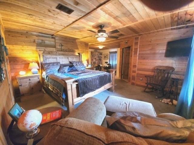 carpeted bedroom with wood walls, ceiling fan, and wood ceiling