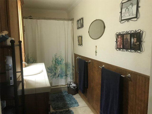 bathroom with ornamental molding, tile floors, and vanity