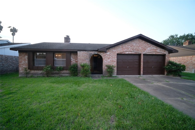 single story home featuring a front lawn and a garage