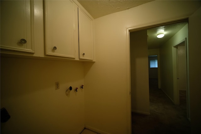 washroom with dark colored carpet and cabinets