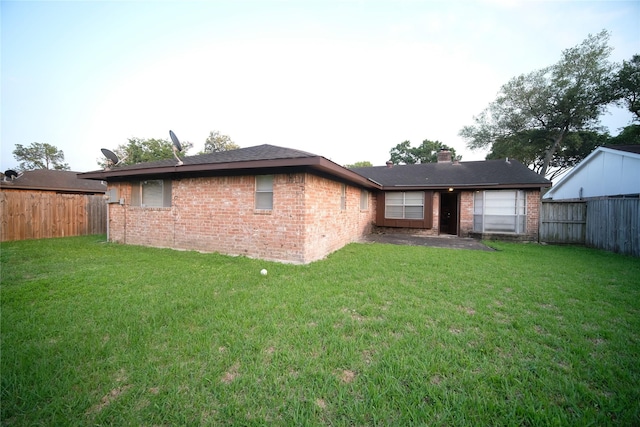 back of property featuring a yard