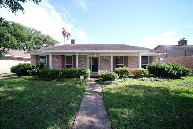 ranch-style house featuring a front yard and a porch