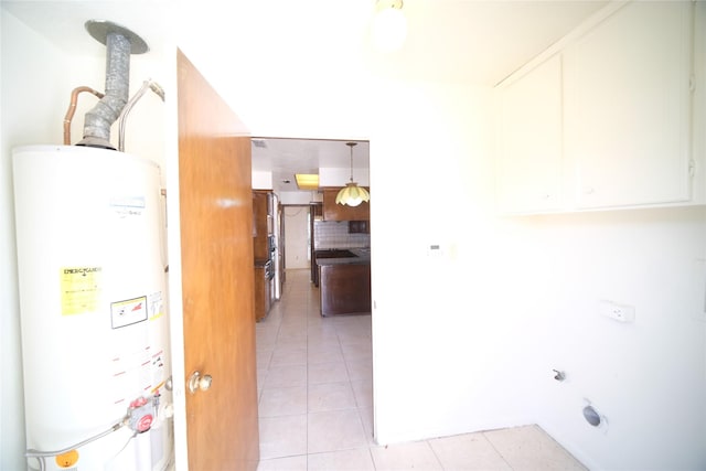 interior space featuring gas water heater and light tile floors