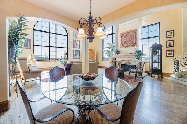 dining space with a notable chandelier and light hardwood / wood-style floors