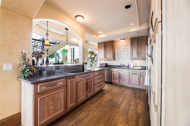 kitchen with dark wood-type flooring, decorative light fixtures, black electric cooktop, sink, and dishwasher