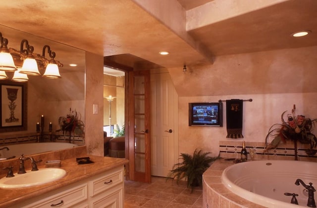 bathroom with tiled bath, tile floors, and vanity