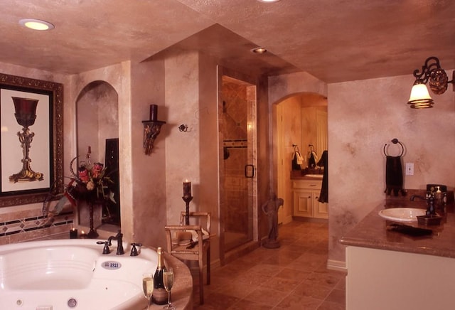 bathroom with tile flooring, plus walk in shower, and vanity