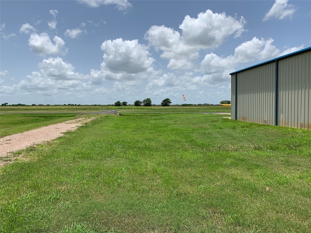 view of yard with a rural view